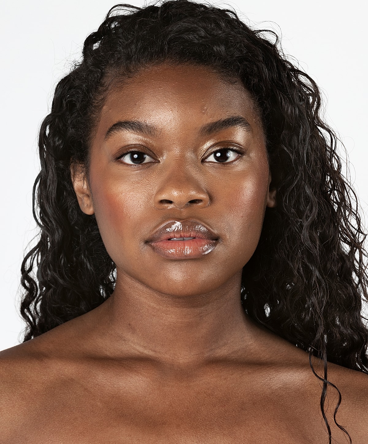 Portrait of a young woman with curly hair.