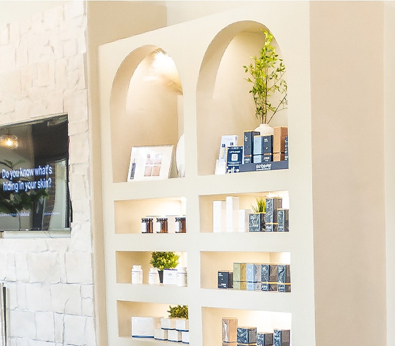 Skincare products displayed on a modern shelf.