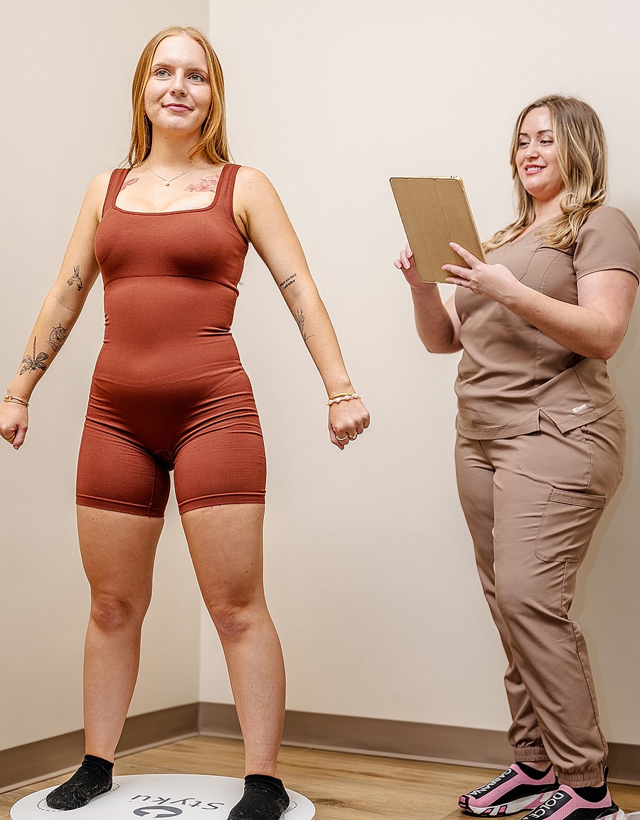 Person posing for assessment with staff observing.