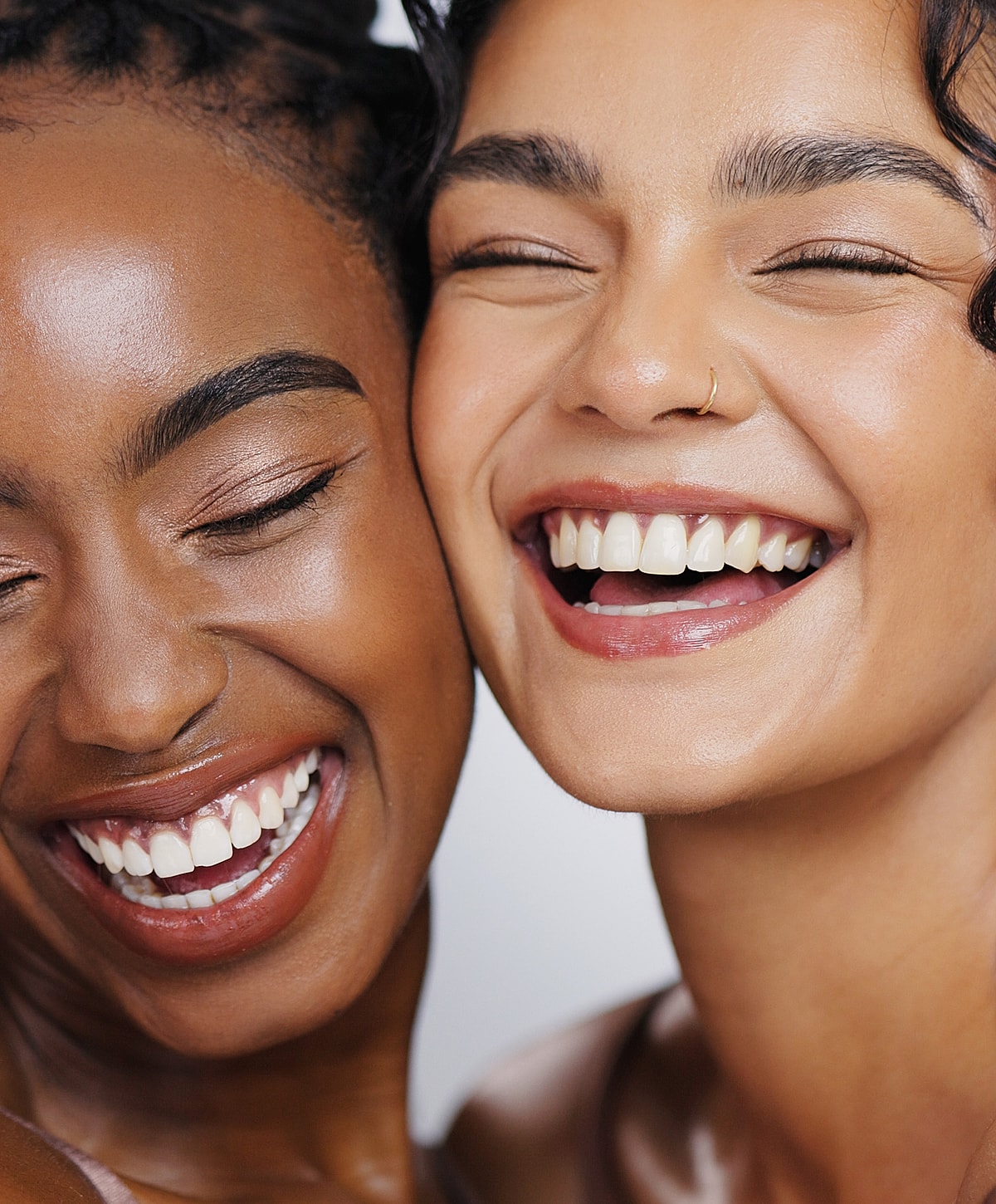 Two women smiling joyfully together.