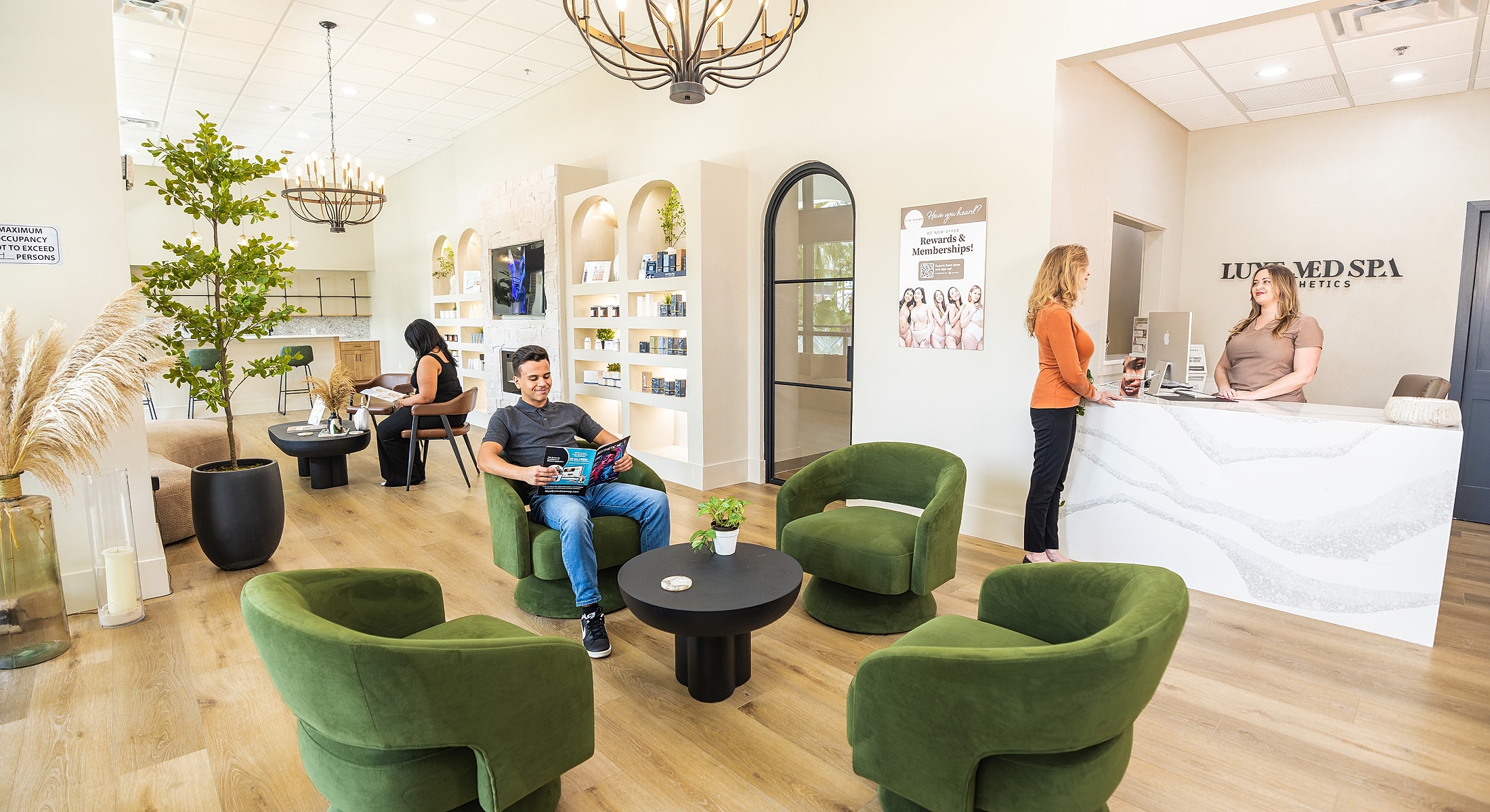 Welcoming spa reception area with customers and staff.